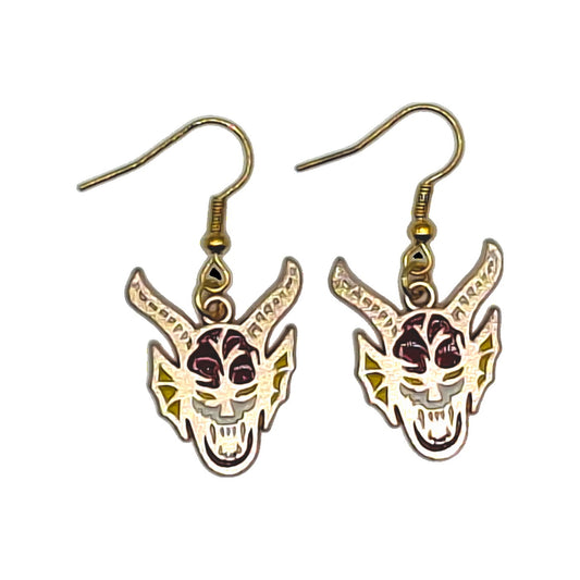 Hellfire Club earrings inspired by Stranger Things, white red and yellow demon-head charms with gold-tone hooks on a white background
