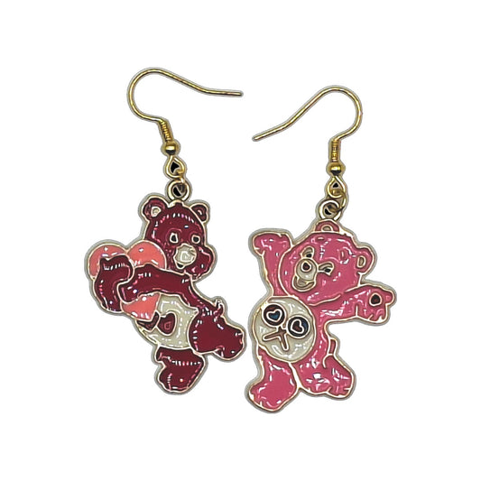 Gloomy Bear creepy-style earrings with two coordinated pink bear charms and gold-tone hooks on a white background